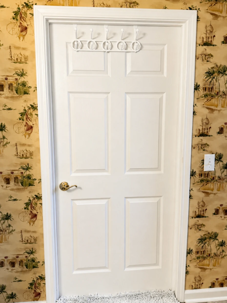 Completed wallpaper installation and white door finishing